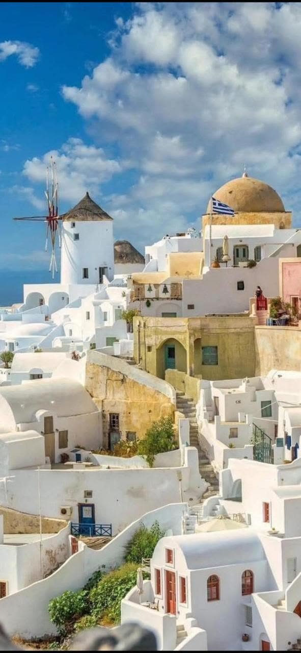The windmill and gold dome of Oia, Santorini