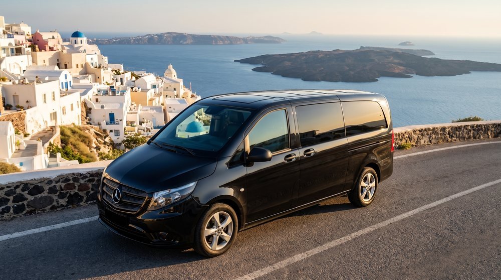 VIP Mercedes van above the Santorini caldera at golden hour